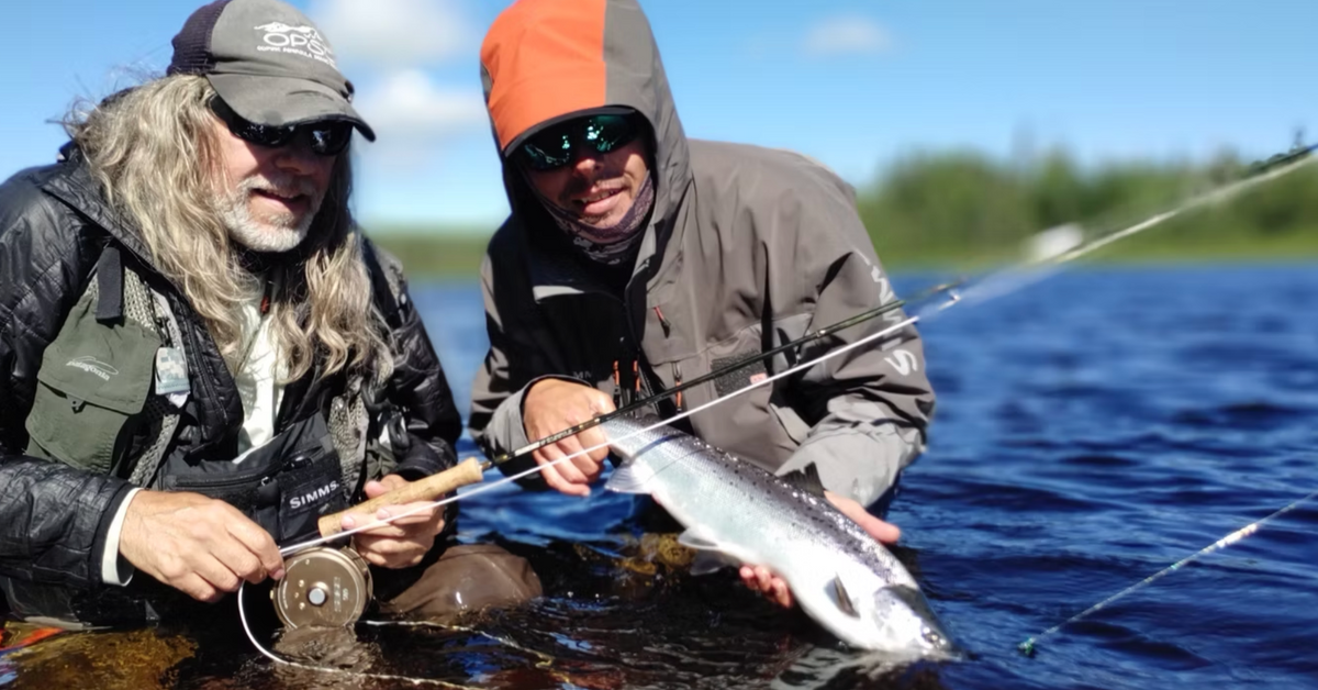 Guide David Hartlin and an angler with an Atlantic salmon on a Newfoundland river