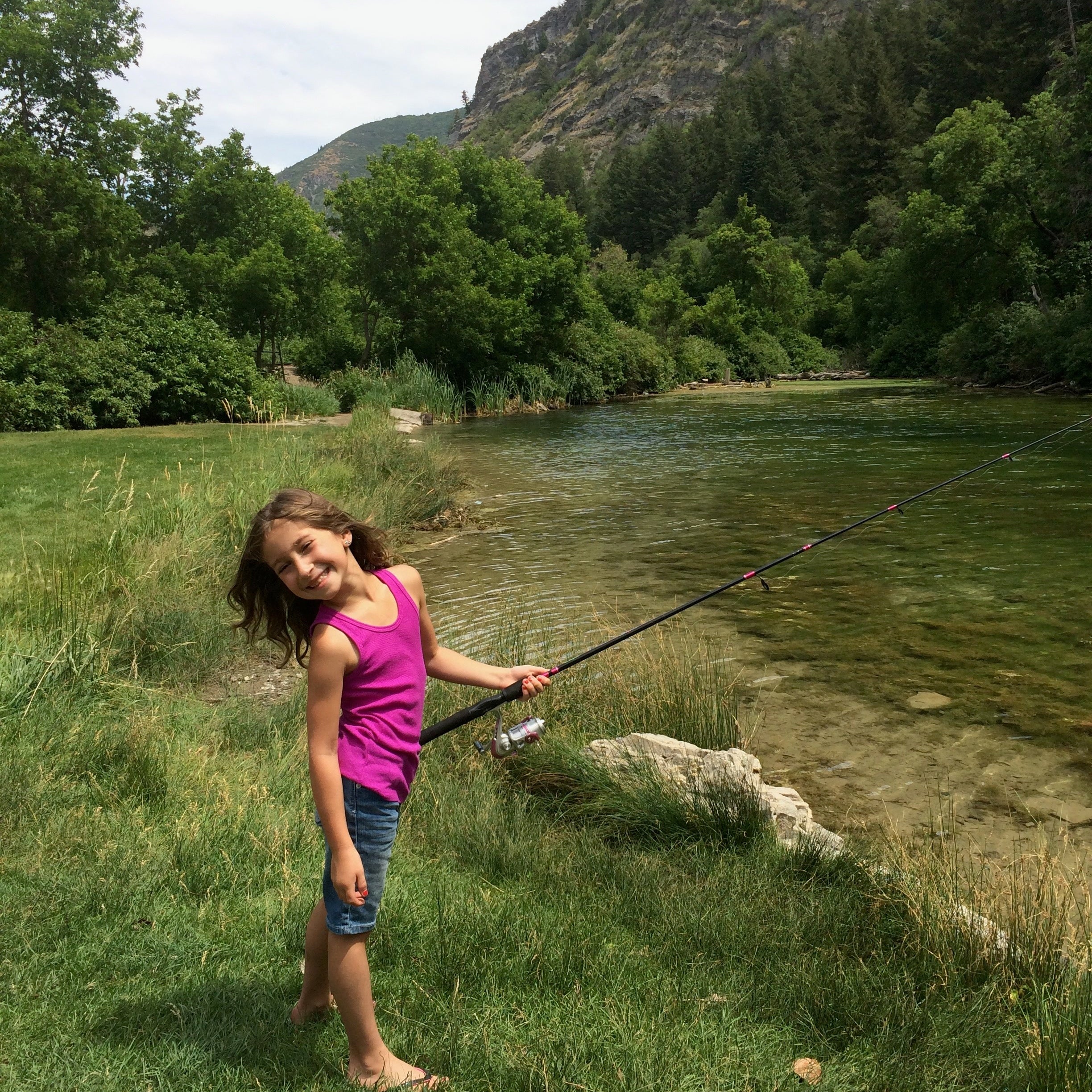 A kid spin fishing from the bank