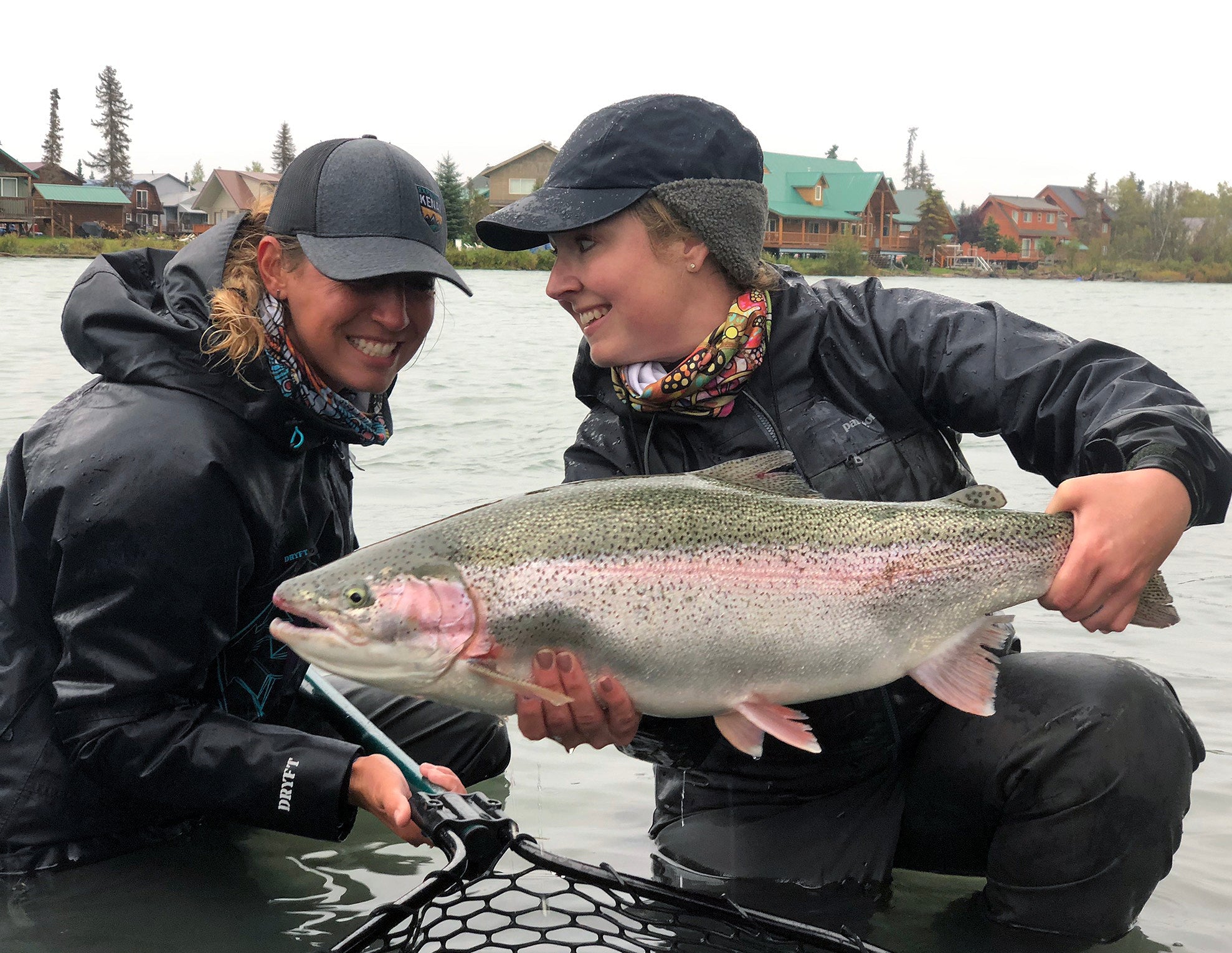 Two anglers with a large Kenai River rainbow trout