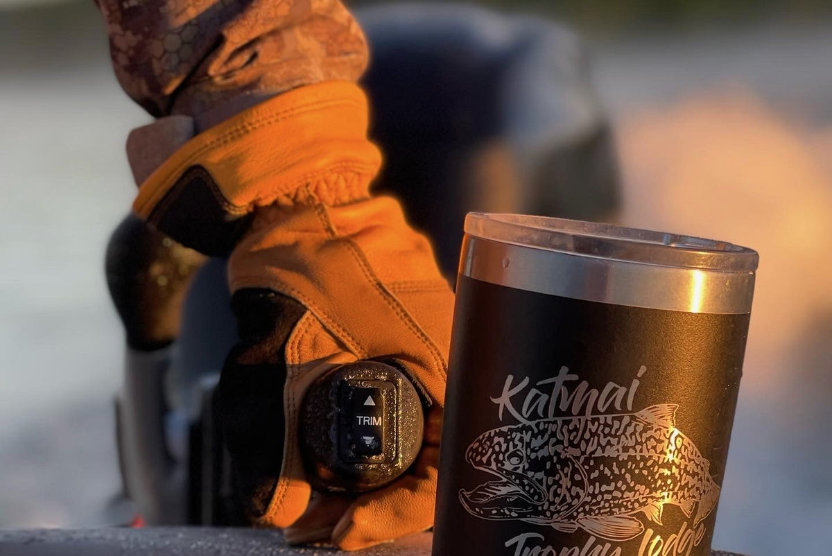 Orange goatskin leather TRUCK glove gripping a boat throttle trim control at sunrise