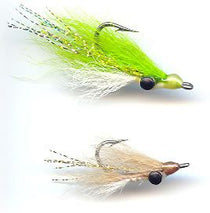 Two minnow-style fishing lures with green, white, and tan fur; black eyes and hooks