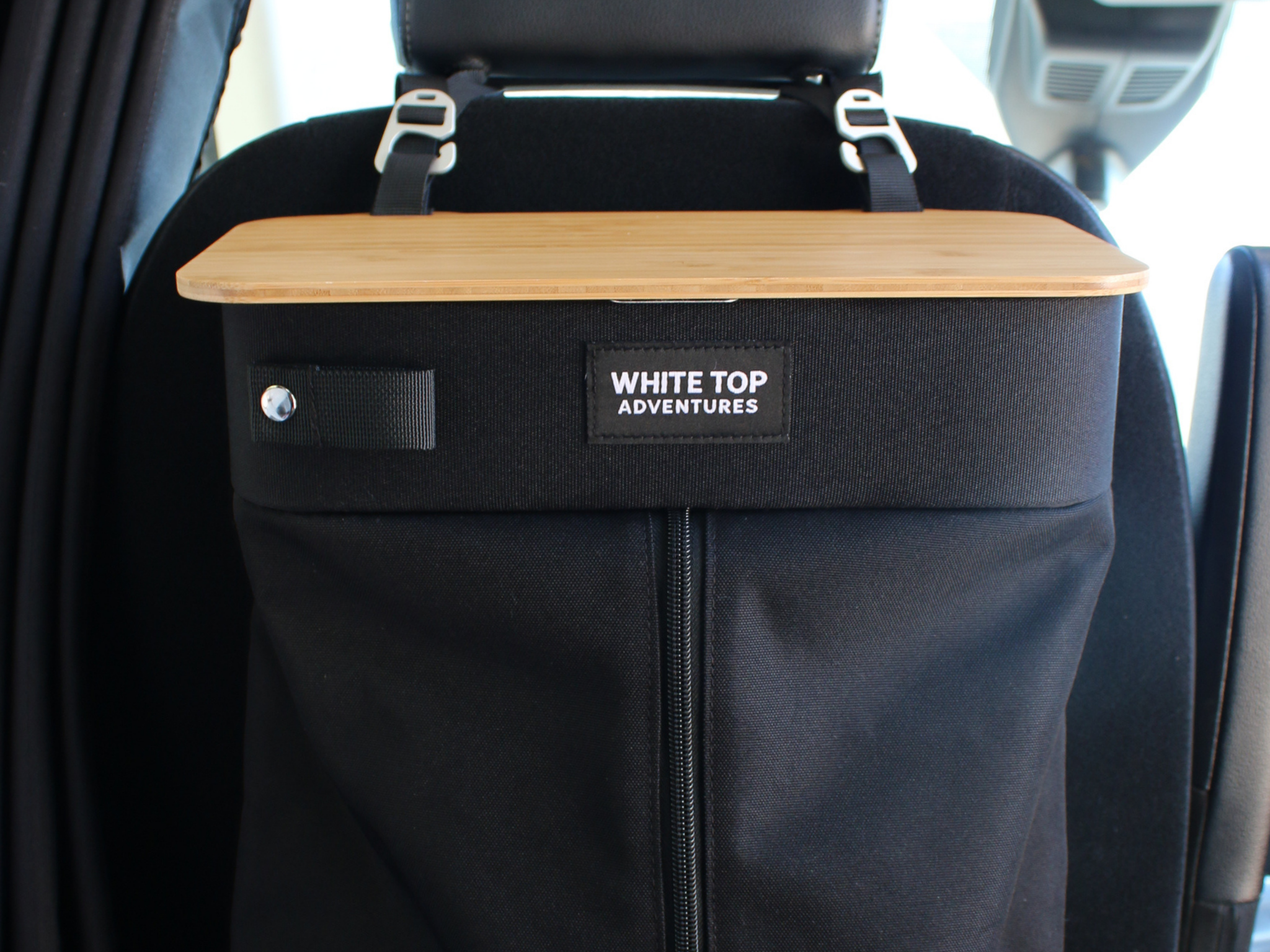 Black hanging trash bag with light wood top and two adjustable seat straps
