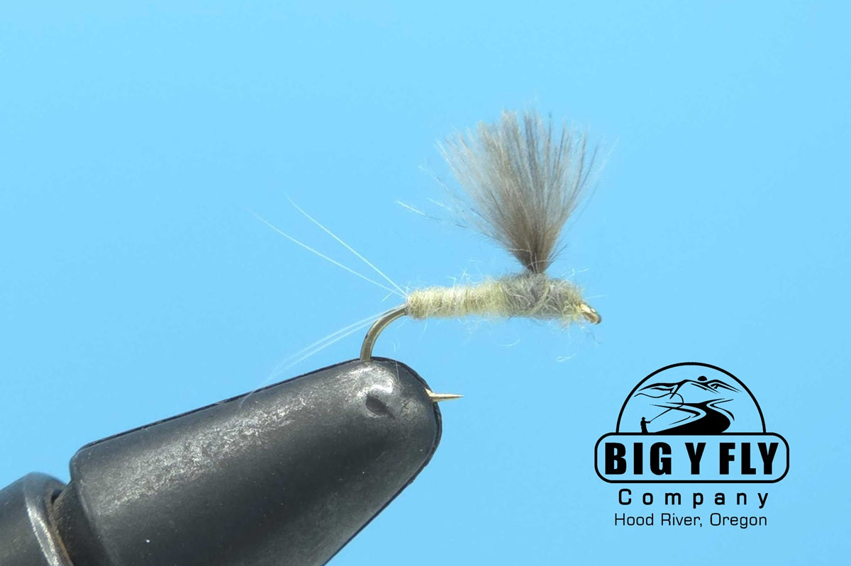 Fishing lure fly with dark body and tan CDC-style feather wing on hook