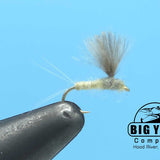 Close-up fishing fly with dark body and tan CDC feather wing on curved hook