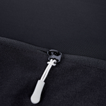 Black storage panel zipper with white pull and loop puller