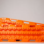 Orange off-road recovery traction boards pair with raised cleats