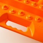 Orange traction board with ActionTrax logo and side handle slot