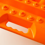 Orange traction board with ActionTrax logo and side handle slot