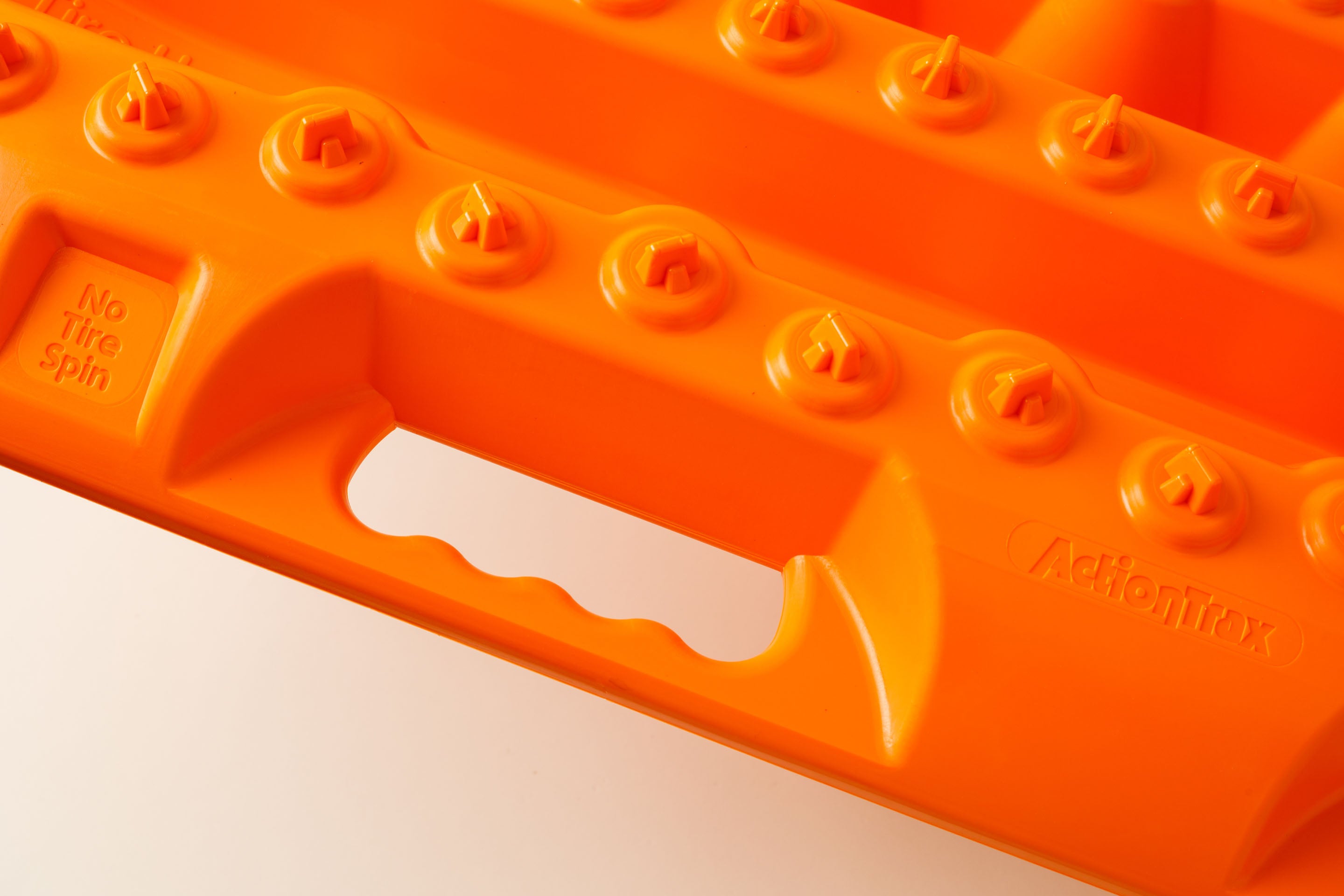 Orange traction board with ActionTrax logo and side handle slot