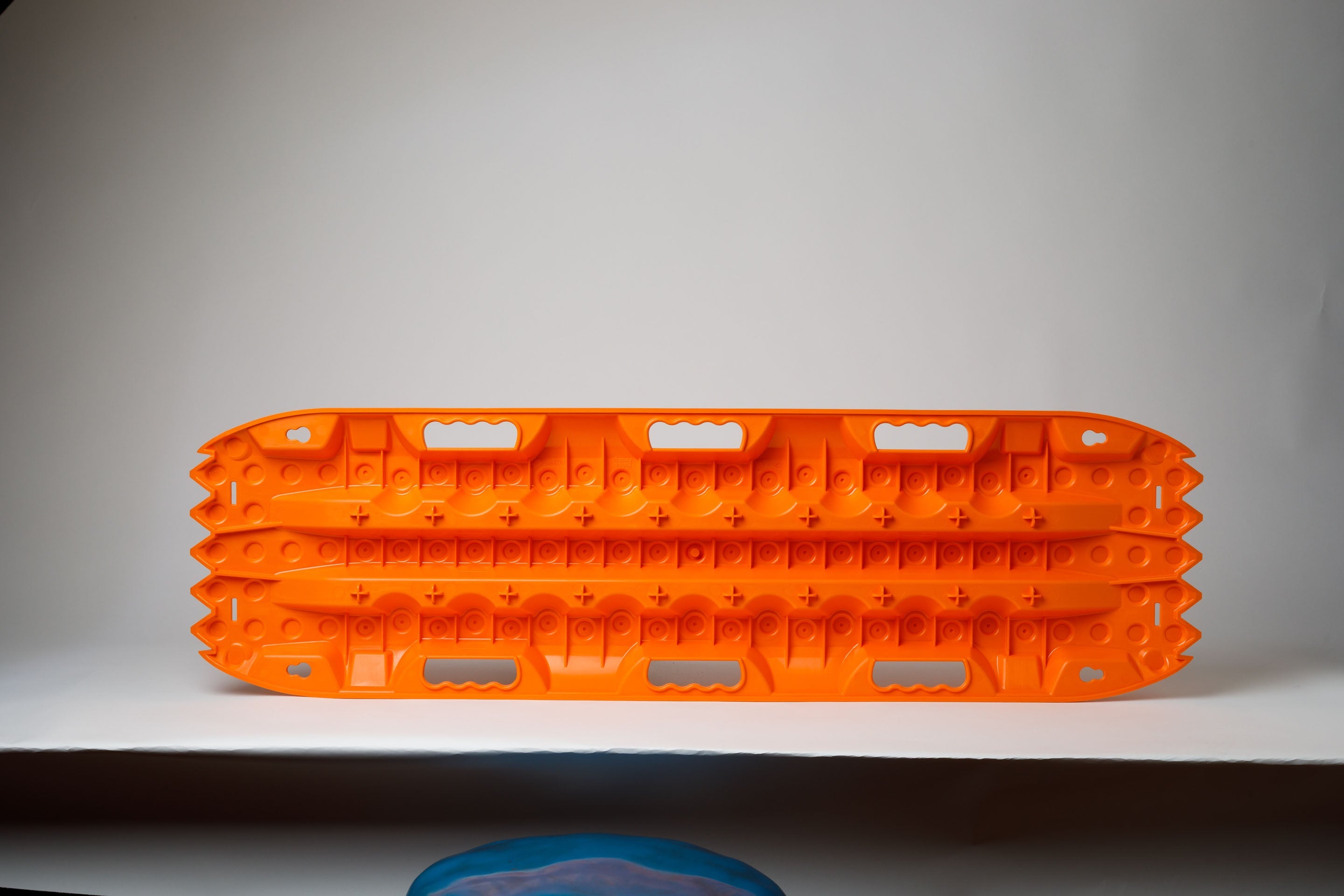 Orange traction recovery board with raised cleats on both sides