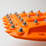 Orange recovery traction mat with metal teeth and bolt studs