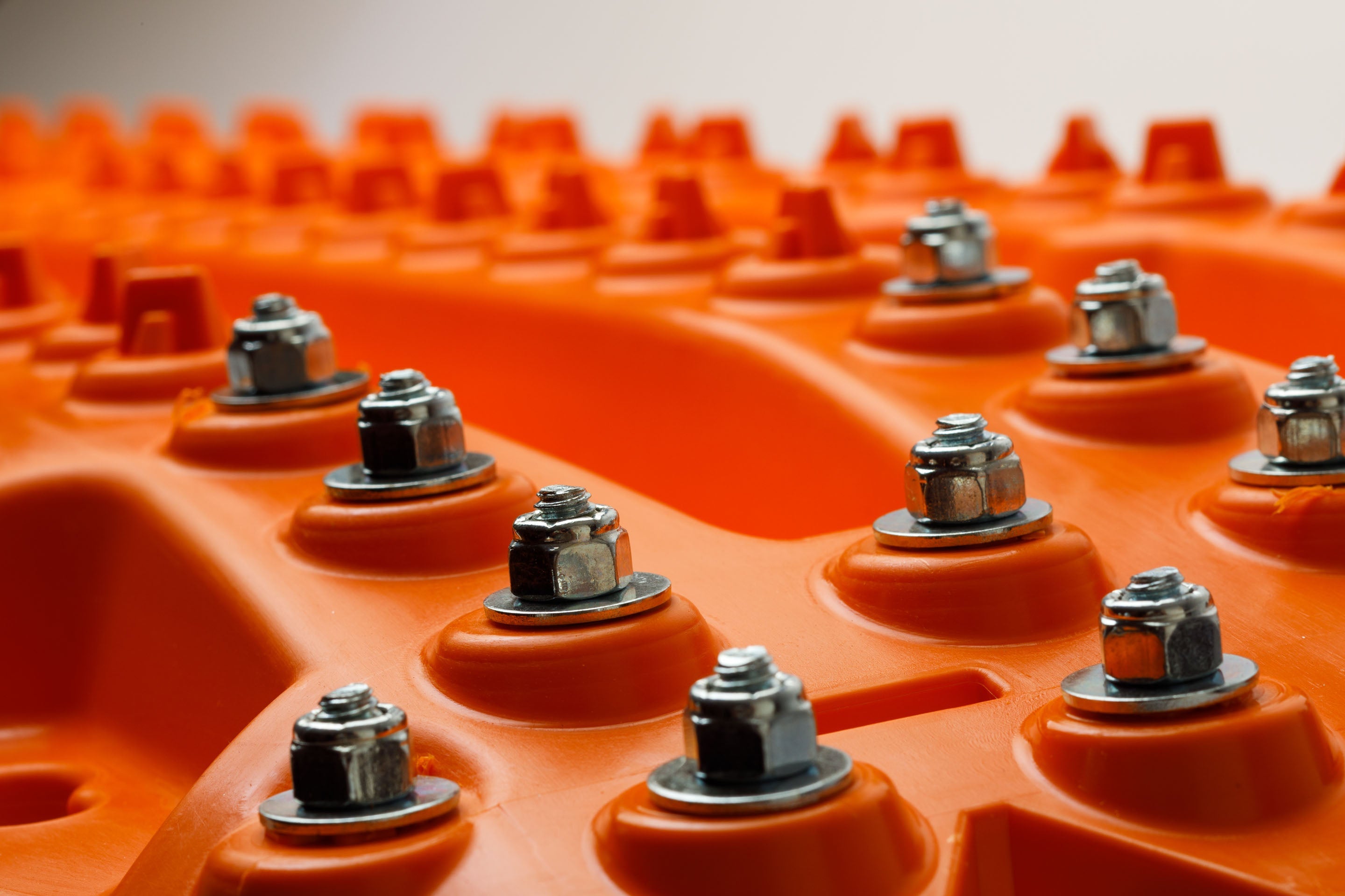 Orange traction board texture with evenly spaced metal studs