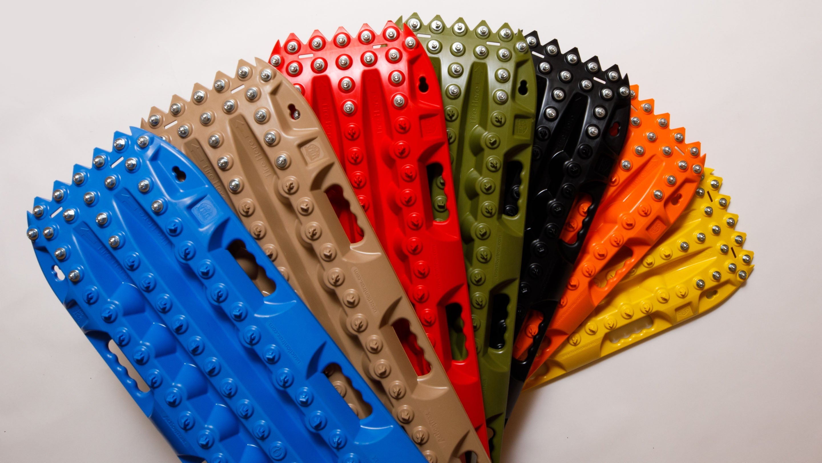 Blue recovery traction mat with metal teeth and raised grip studs