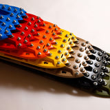 Studded traction recovery board pair in blue, red, yellow, and black