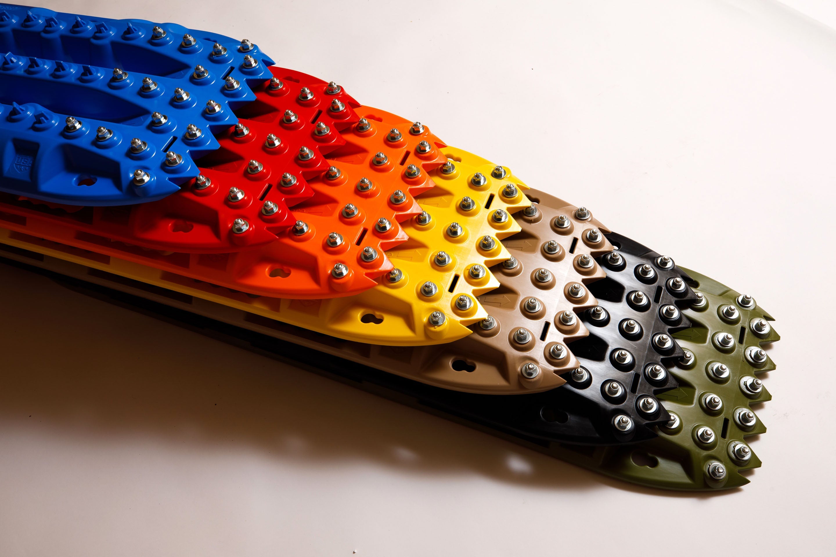 Studded traction recovery board pair in blue, red, yellow, and black