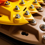 Tan recovery traction board with metal teeth studs on ridged surface