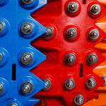 Close-up of blue and orange traction teeth with steel bolts
