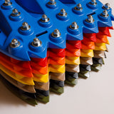Blue traction recovery boards stack with metal studs and bolts