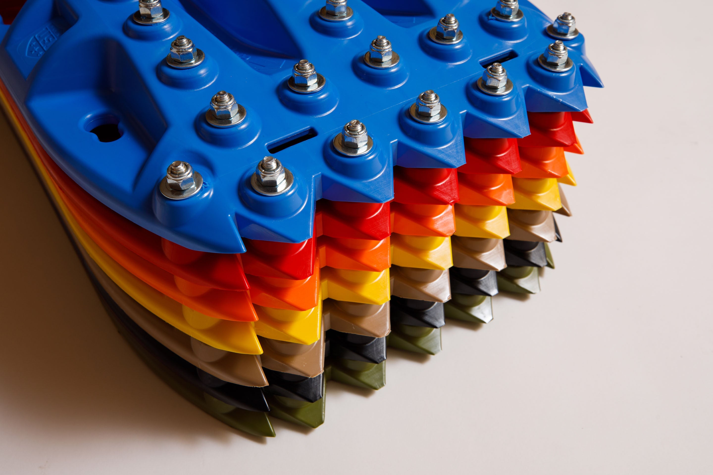 Blue traction recovery boards stack with metal studs and bolts