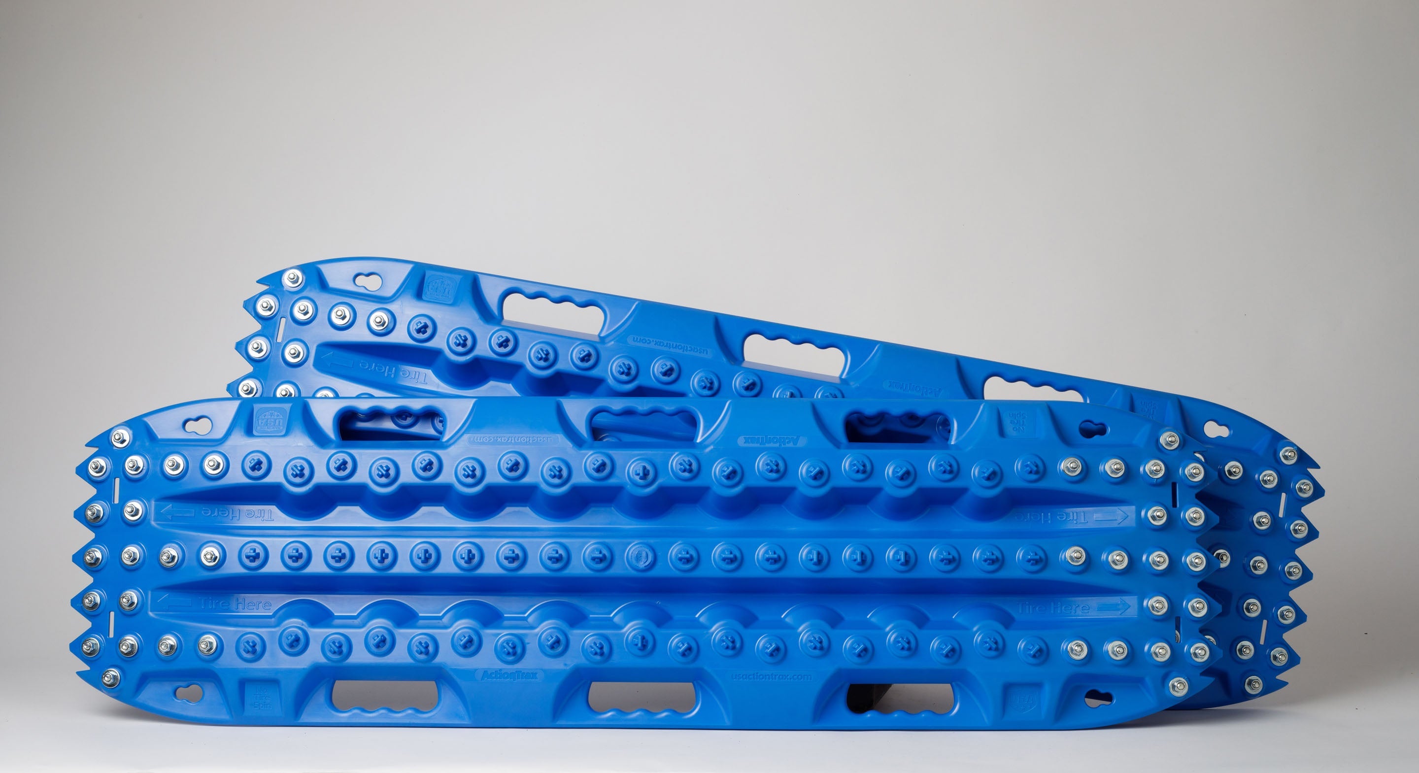 Blue recovery traction board with metal teeth along the edges