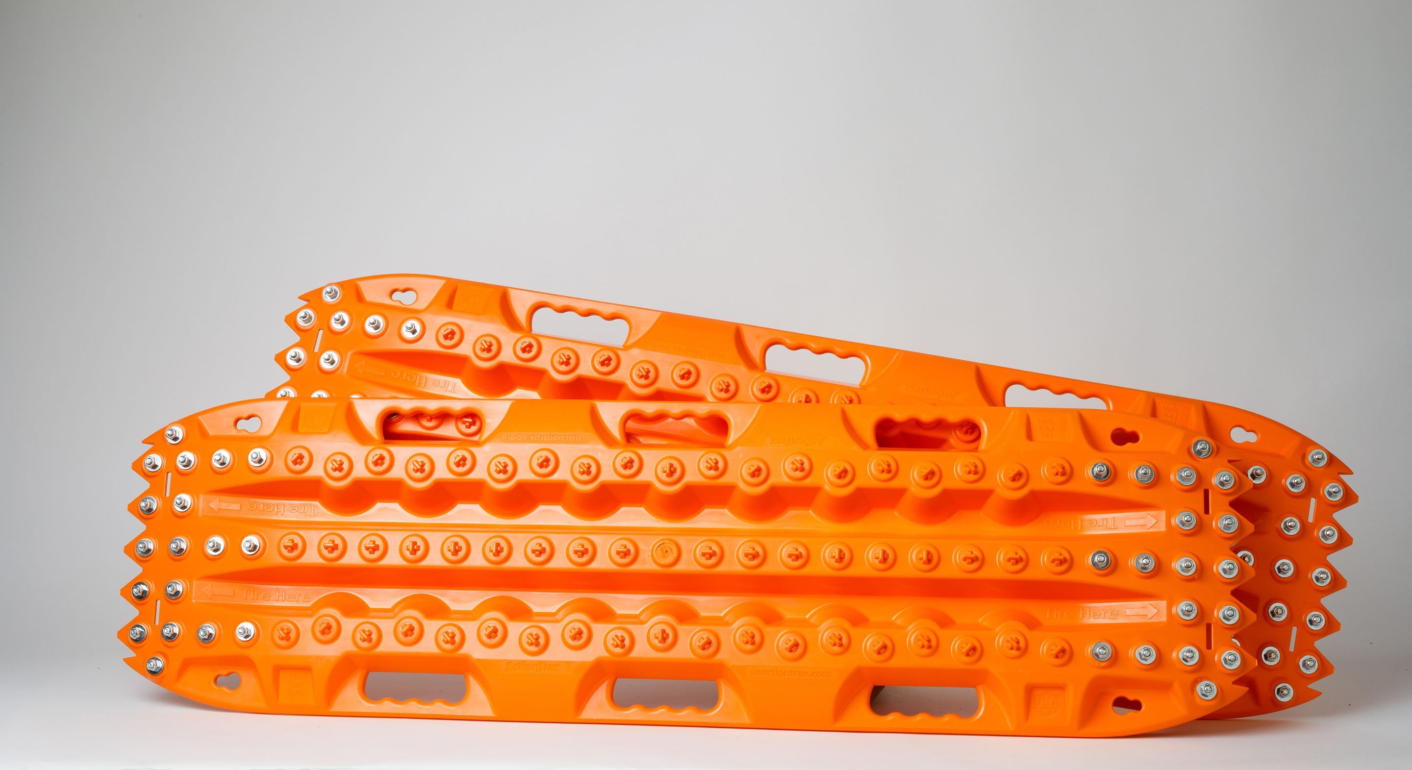 Orange traction recovery board pair, side view with metal studs