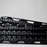 Pair of black traction recovery mats with metal teeth across the tread