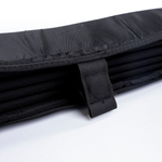 Black privacy curtain fold with interior mesh-like fabric strap