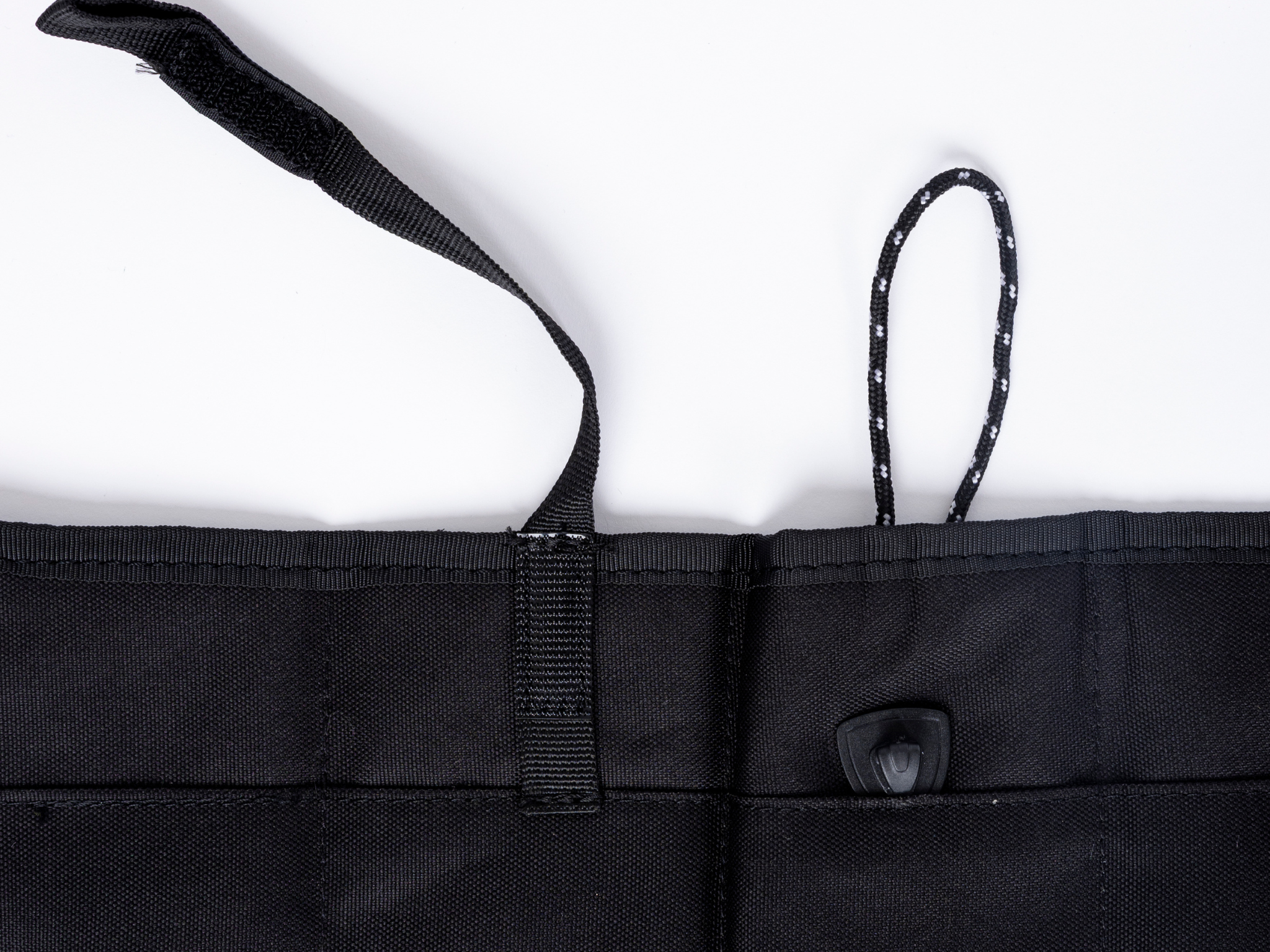 Black privacy curtain header with center strap and snap button on panel