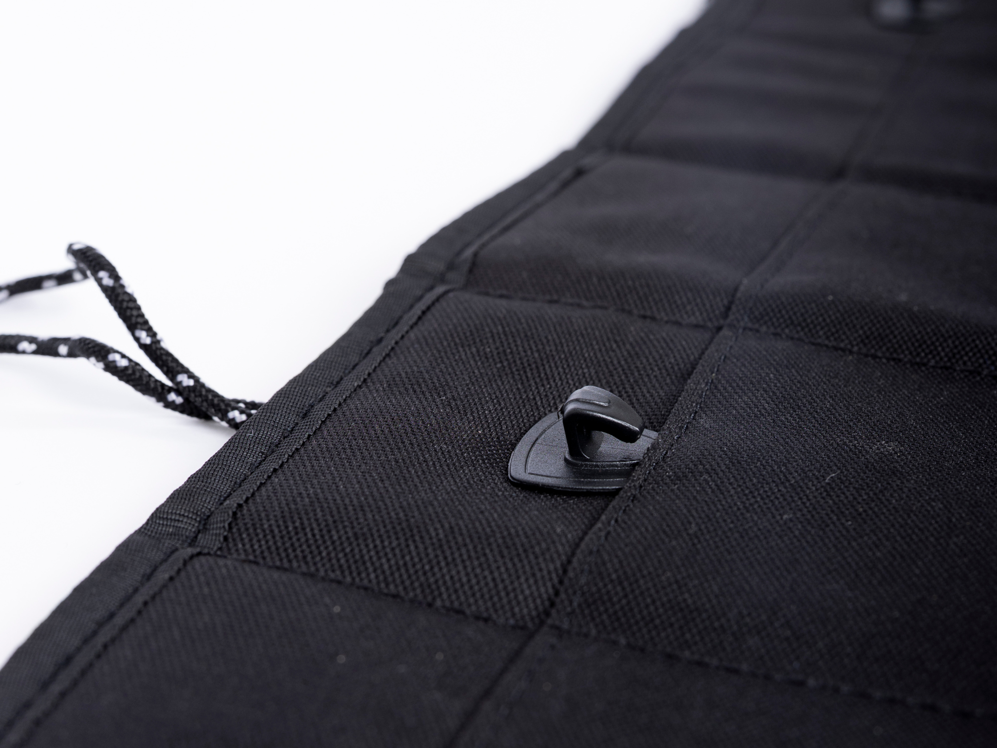 Black privacy curtain corner with stitched fabric and plastic snap fastener