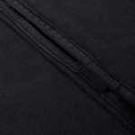 Black curtain fabric close-up showing textured weave and layered stitching