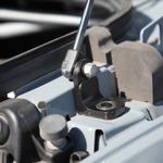 Installed hood strut on Sprinter van, showing bracket, pivot bolt, and bearing