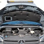 Open hood supported by hood struts in Sprinter van engine bay