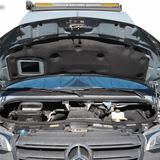 Open hood supported by hood struts in Sprinter van engine bay