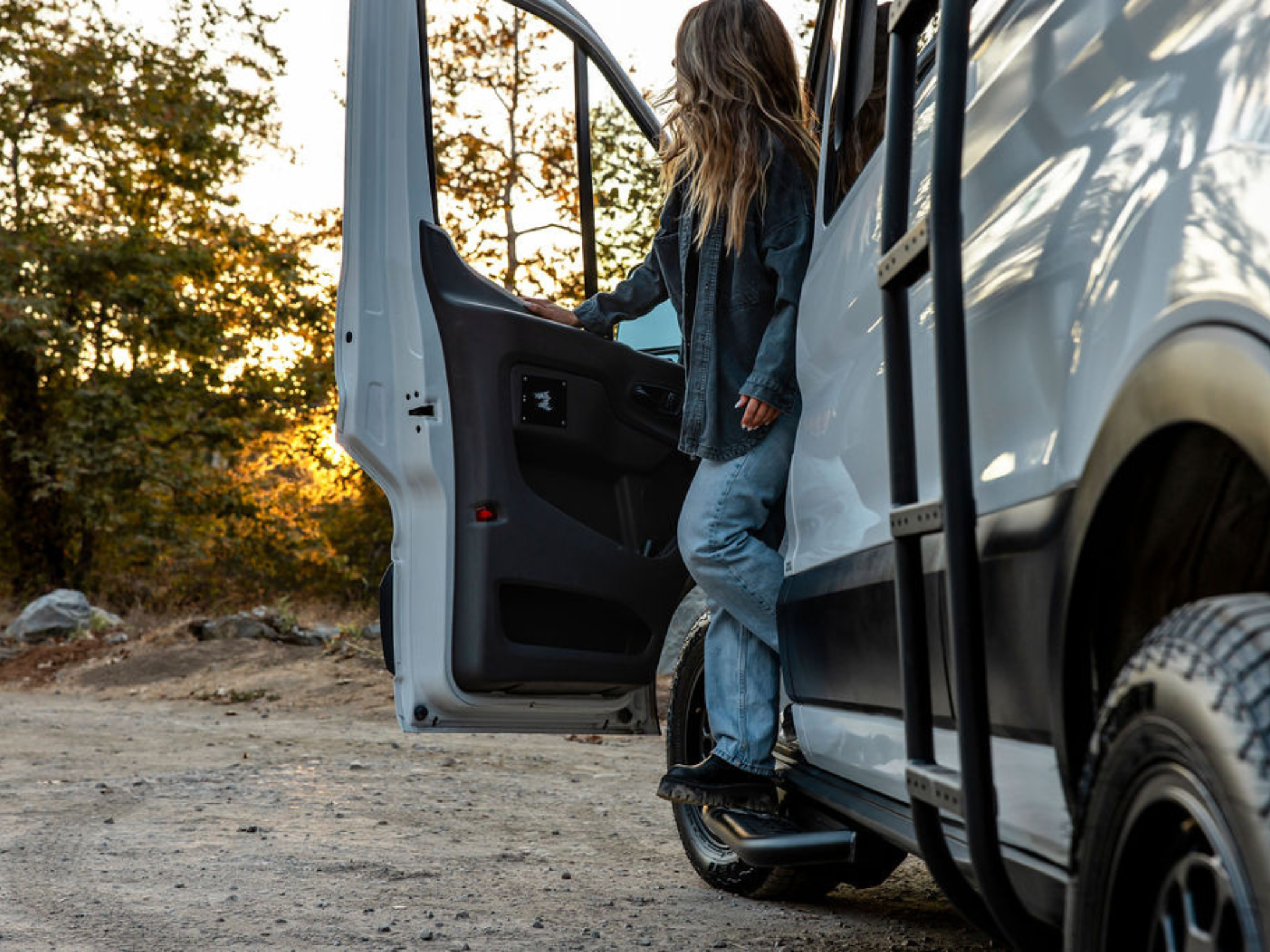 Black side steps on Ford Transit van, showing angled step bar design