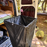 Portable shower kit with black side panels and front mesh pocket for accessories