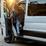 Black side step installed on Ford Transit door area with perforated tread
