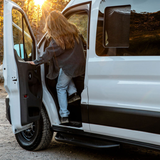 Black side step installed on Ford Transit door area with perforated tread