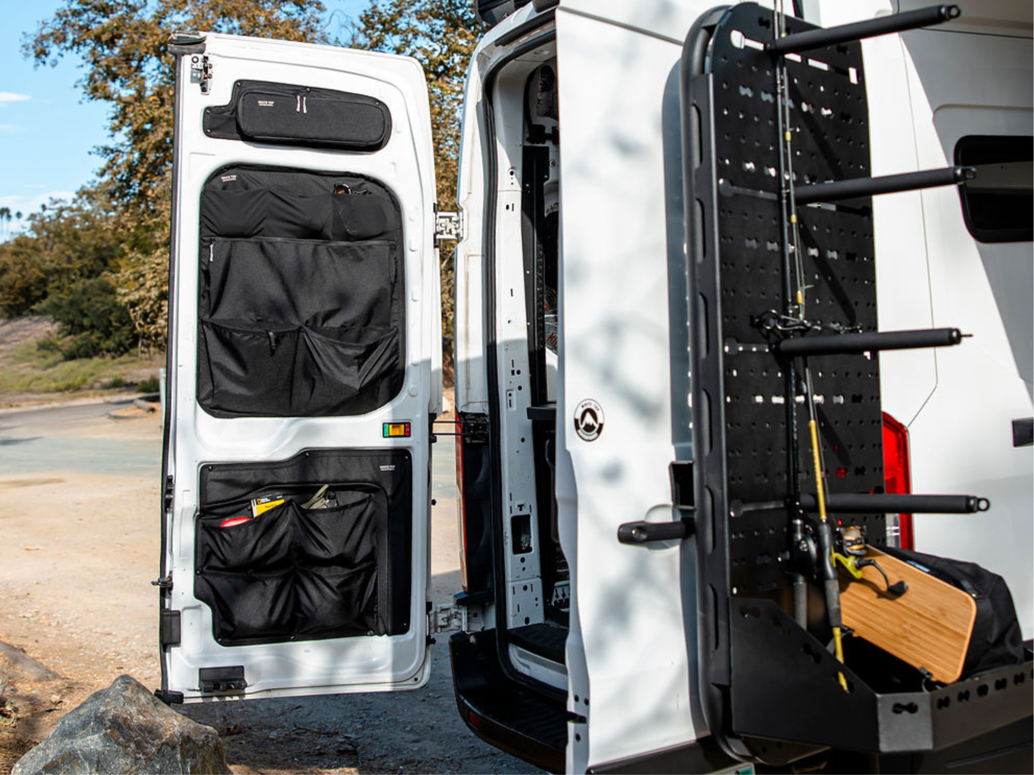 Passenger-side rear door storage rack with perforated pegboard and black storage pouches