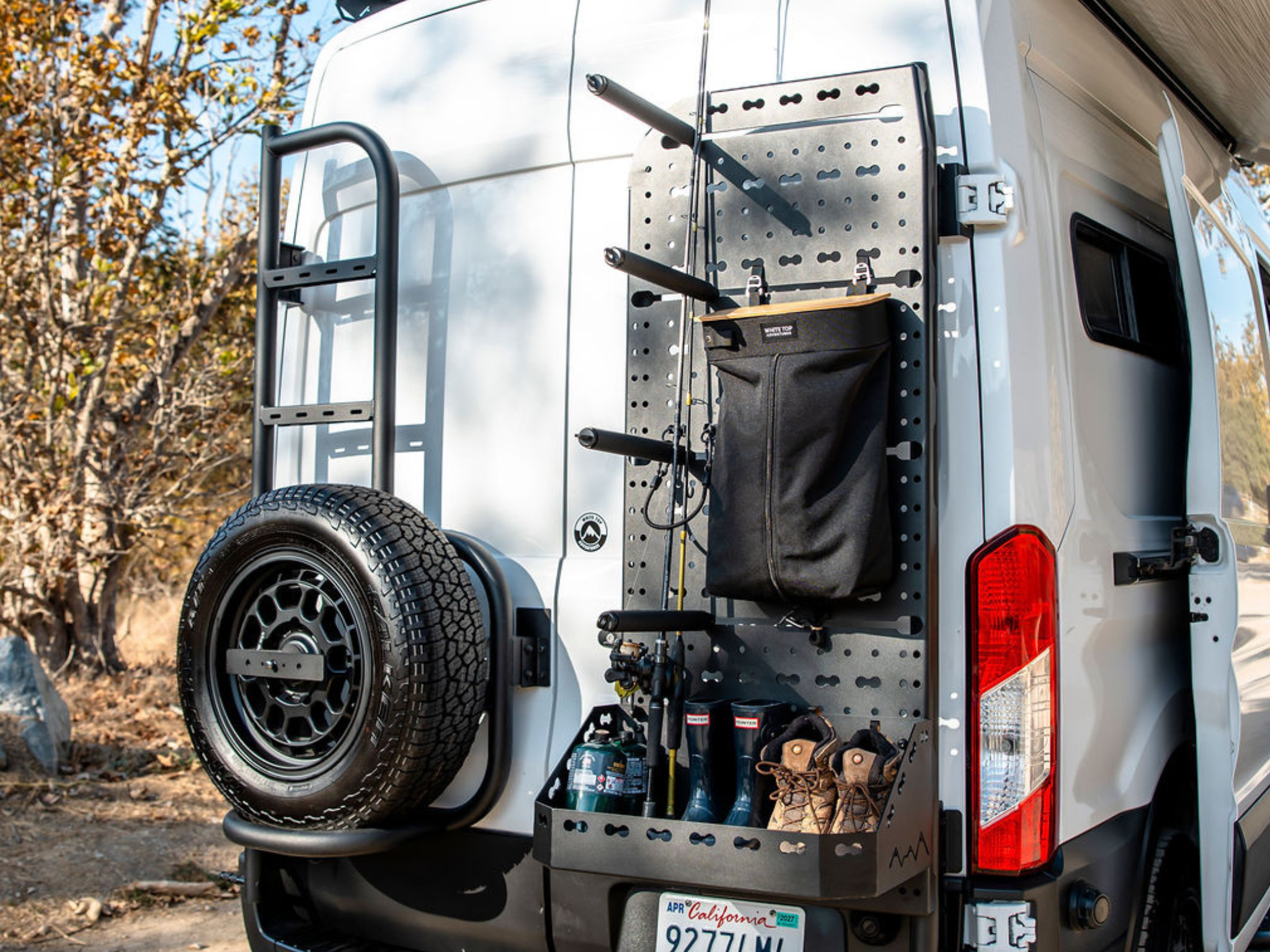 Passenger-side rear door storage rack with perforated pegboard and black hanging pouches