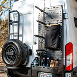 Passenger-side rear door storage rack with perforated pegboard and black hanging pouches