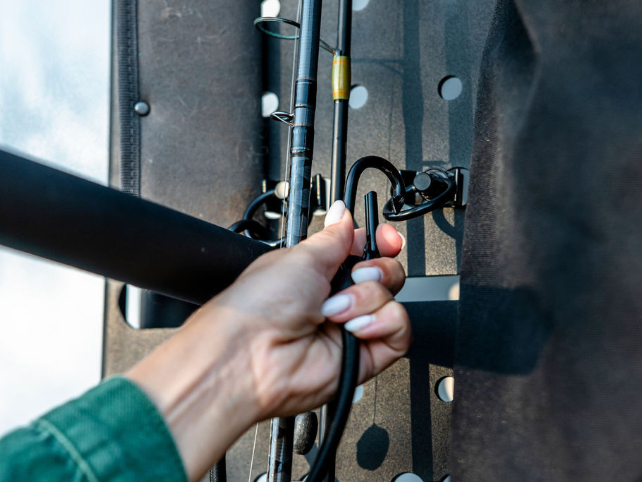 Hand attaching a tool bracket to the perforated rear-door storage rack panel