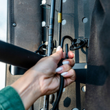 Hand attaching a tool bracket to the perforated rear-door storage rack panel