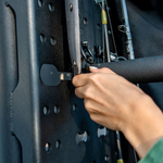 Hand securing accessories to a perforated rear-door rack panel with metal mounting posts
