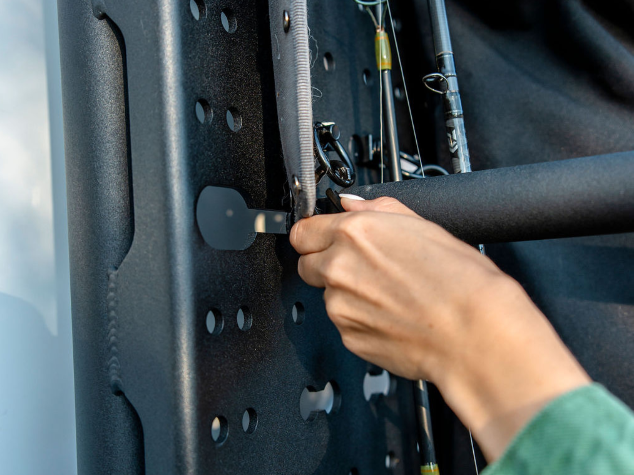 Hand securing accessories to a perforated rear-door rack panel with metal mounting posts