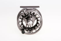 Gunmetal fly fishing reel with black spool, perforated arbor, and side handle.