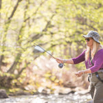 Bead-head nymph fly on line while angler casts by river
