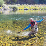Bead-head nymph fly on line while angler catches fish in clear water