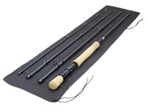 Fly fishing rod with cork handle and black reel seat, laid in fabric rod case