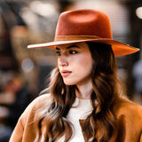 Rust orange wool felt fedora worn with wide flat brim