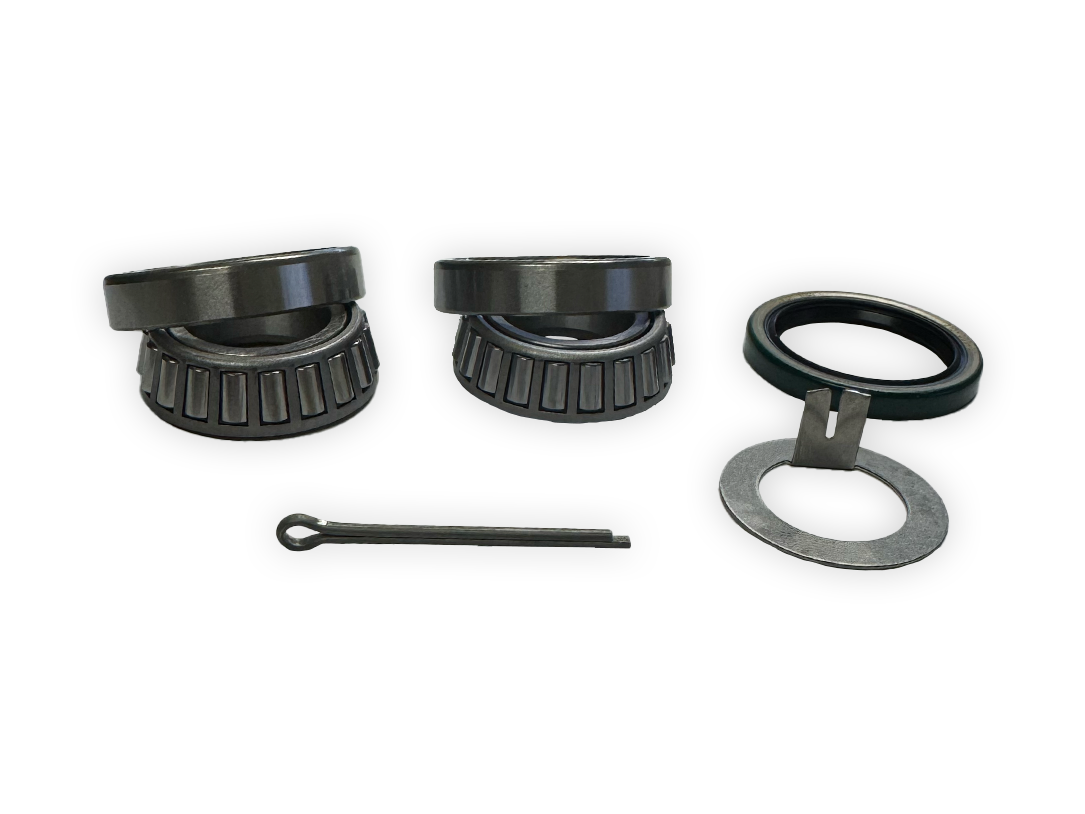 Trailer bearing kit with two roller bearings, seal, and retaining parts